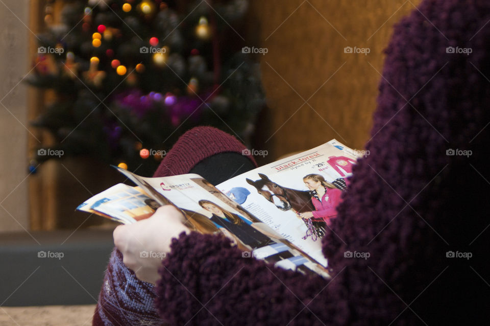 girl reading a magazine on the sofa in the evening