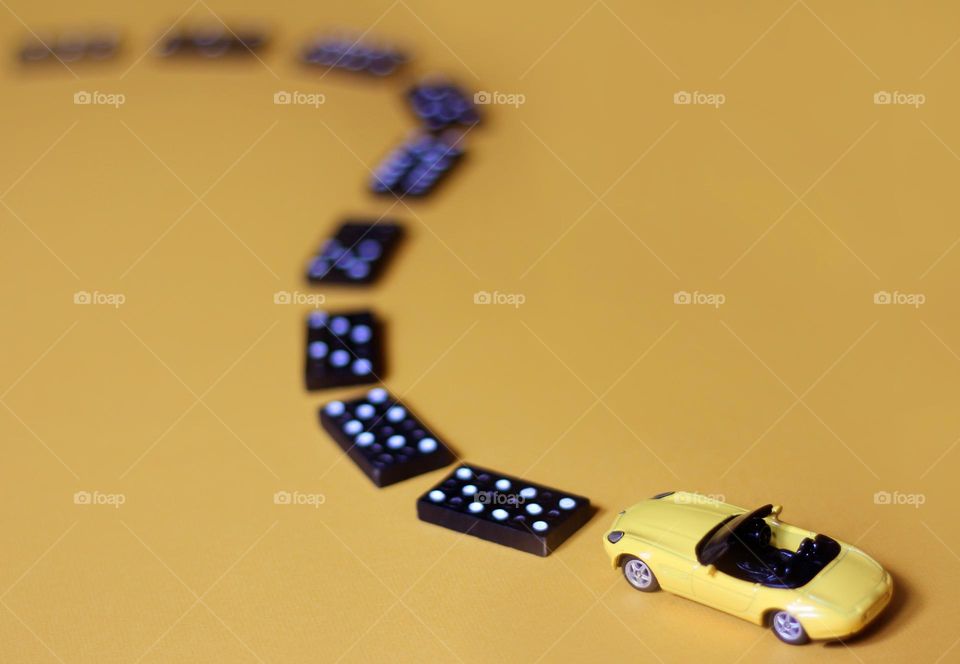 Playing with toy car and domino