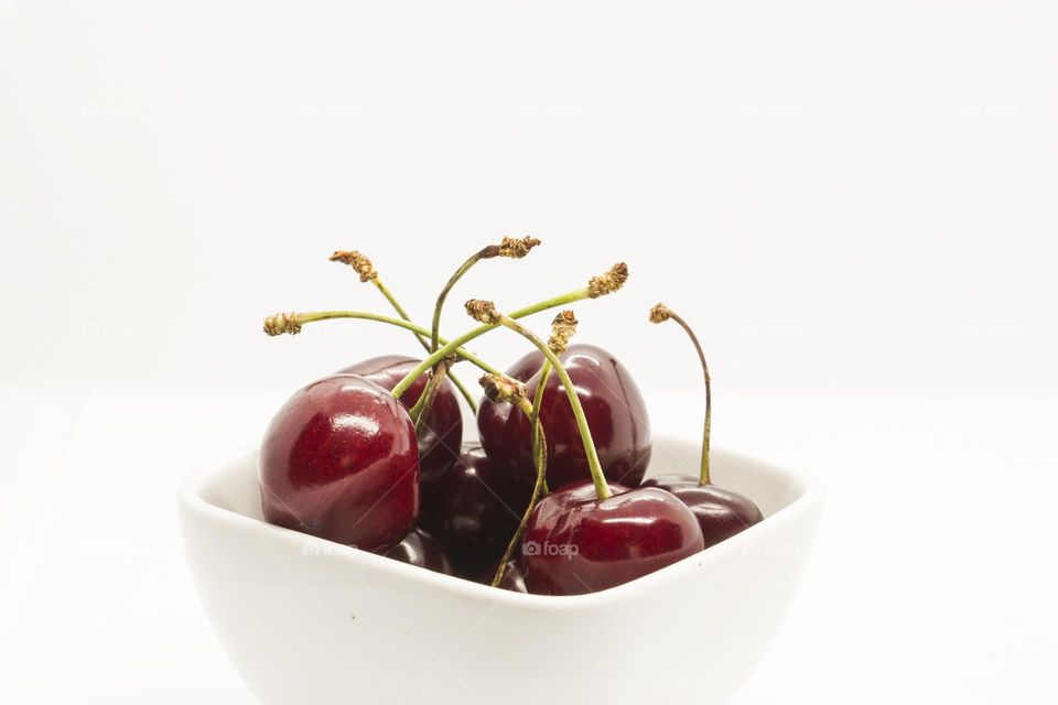Ripe cherry fruits on white background