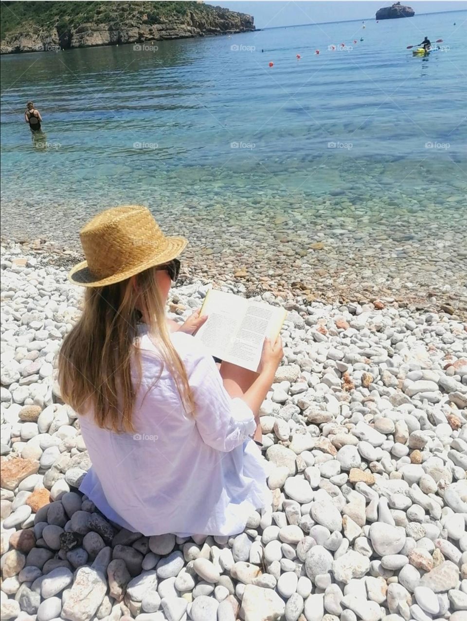 woman reading on the beach