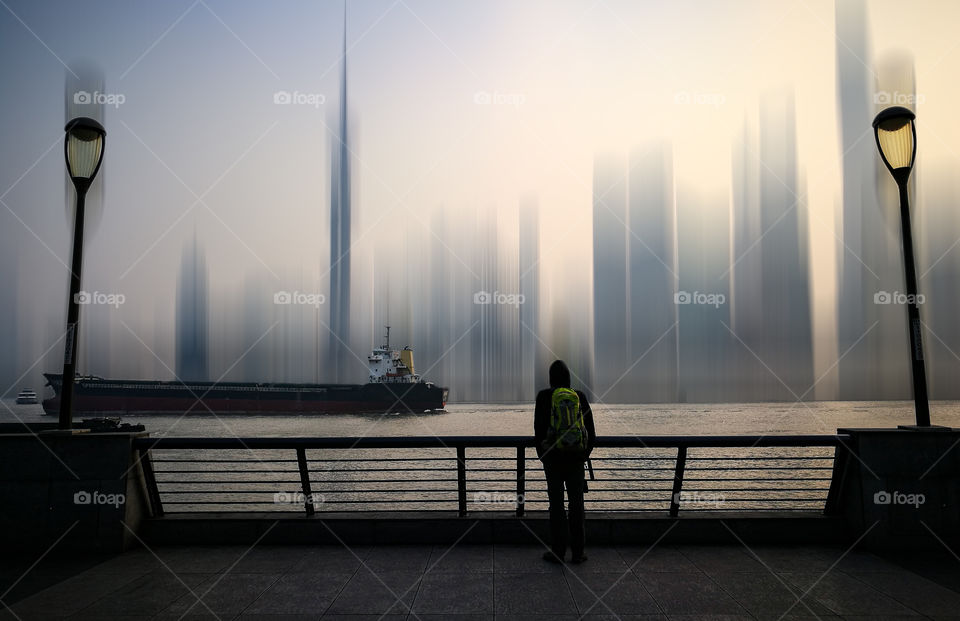 Man standing against abstract Shanghai Skyline