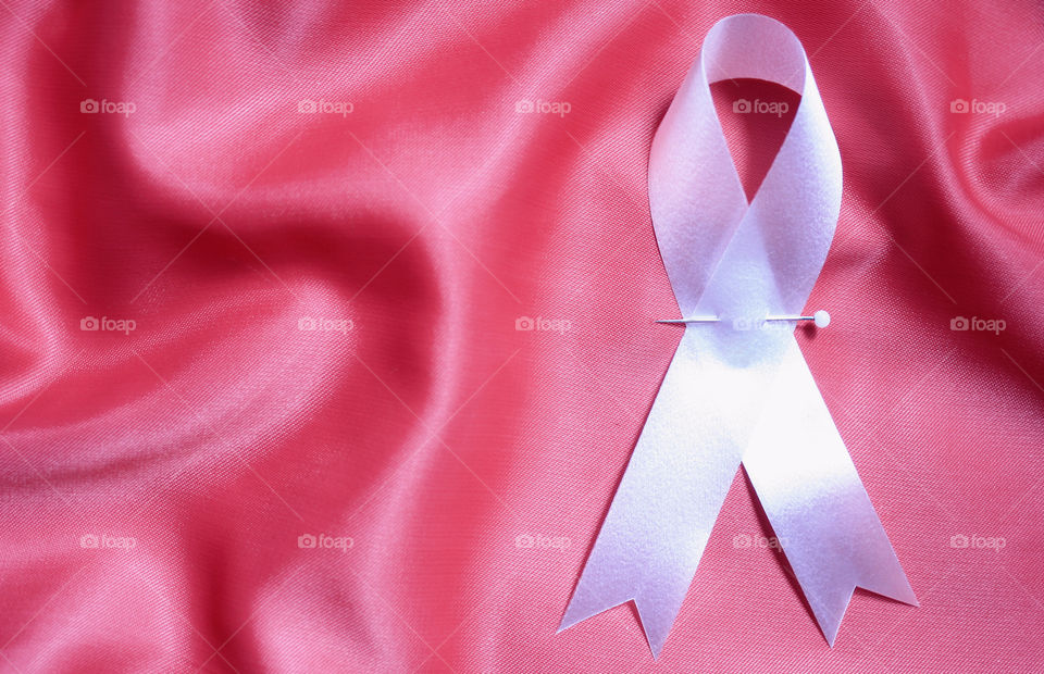 A white ribbon on a pink background 2