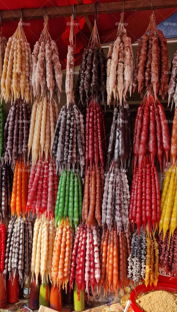 Rows of Churchkhela Georgian sweet grape must sweet desert food at a market in Tbilisi, Georgia.