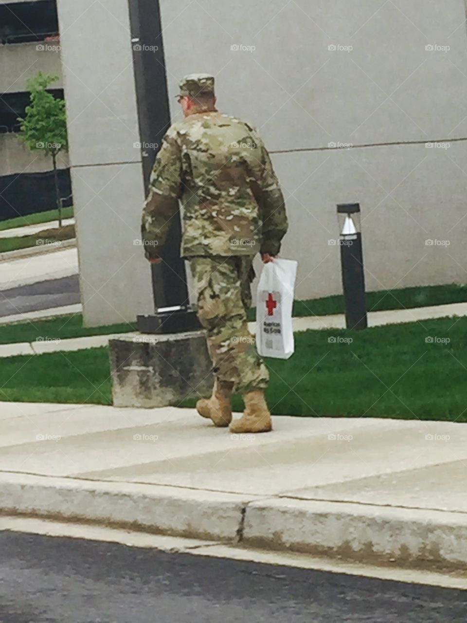 Military walking Red Cross bag
