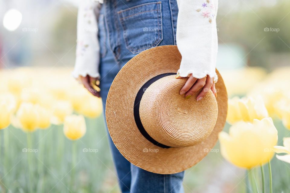 Woman holding straw hat