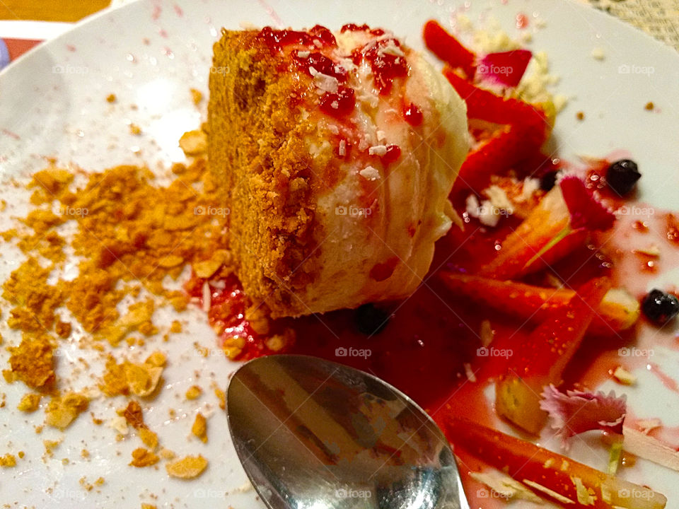 Delicious cheesecake covered by red fruits