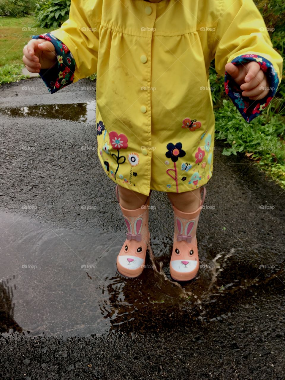 Girl playing in the puddles