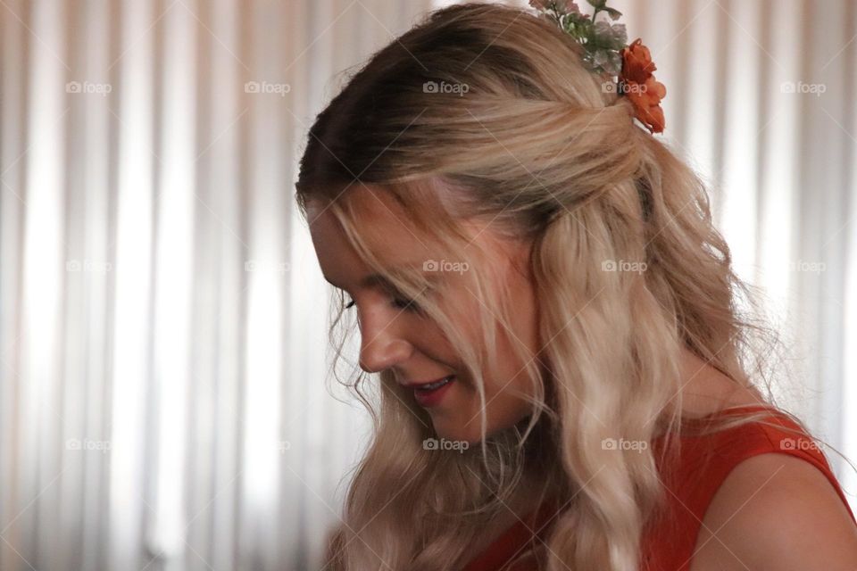 Girl with long blonde wavy hair with flowers 