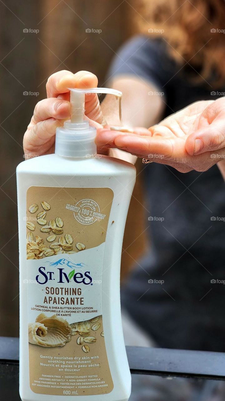 Using St. Ives body lotion.