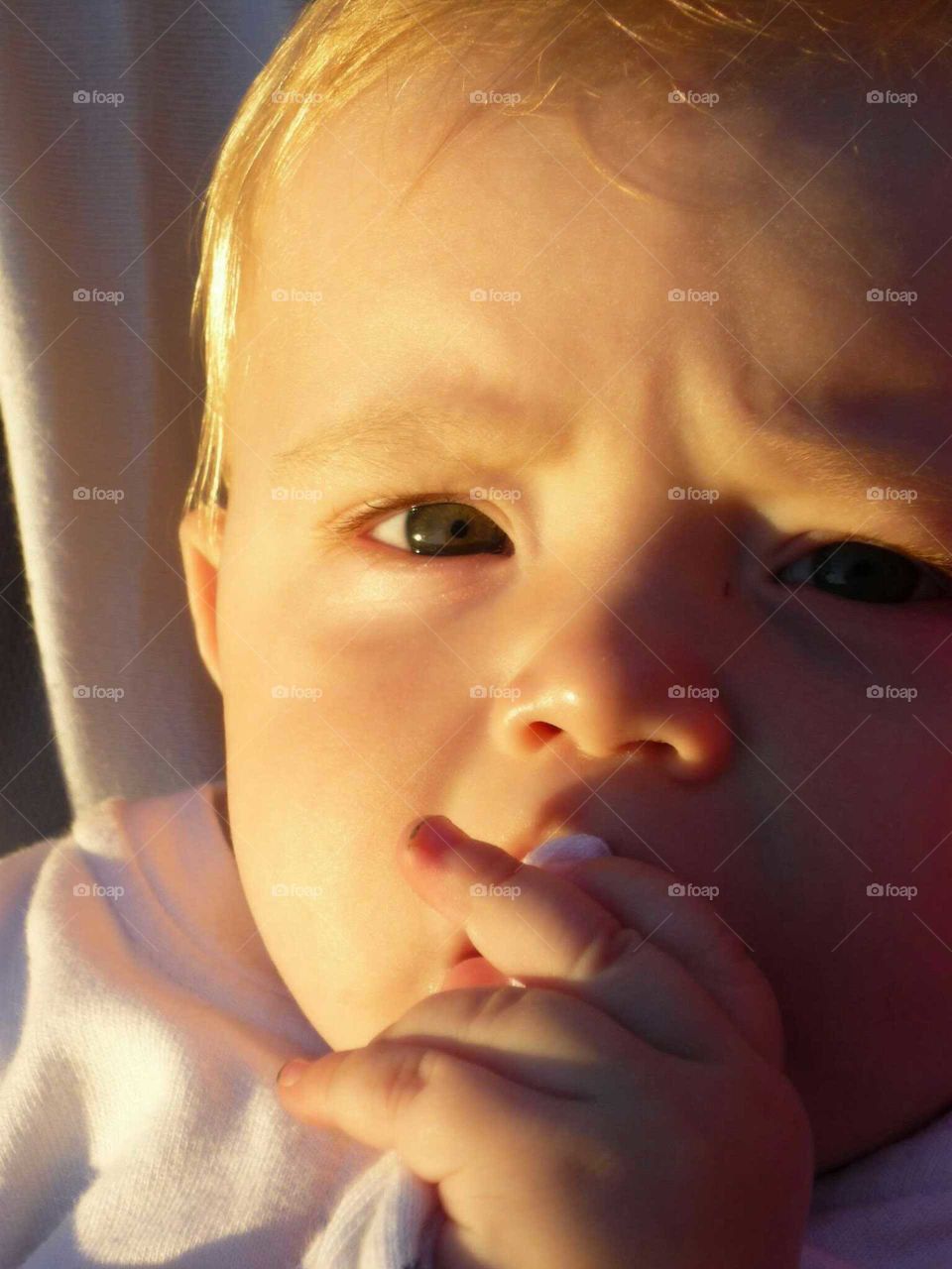 newborn  thinking. kid With sun in his face thinking