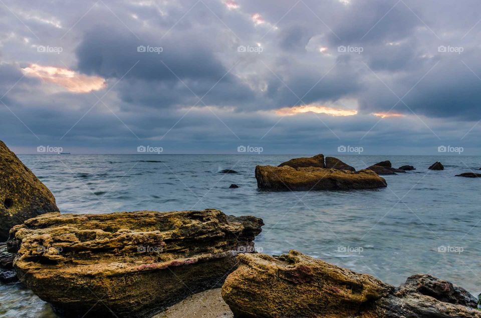 seascape and stones during sunset