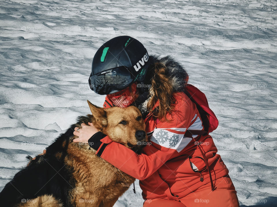 woman and her dog friend skiing