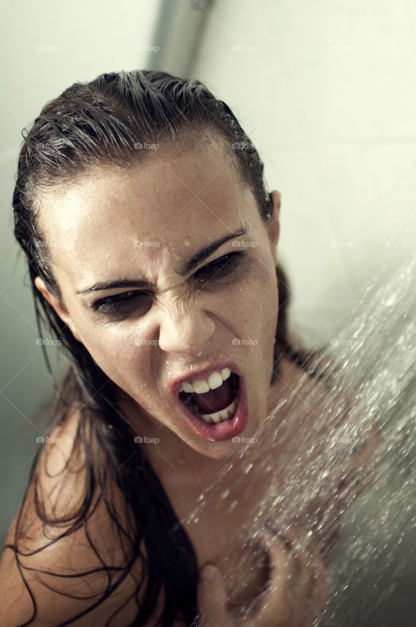 Woman making funny face during bath in the bathroom