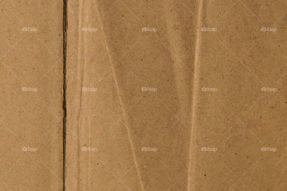 Surface of cut and torn sheet brown color old and vintage cardboard paper box. Abstract texture background close up. Natural canvas pattern background. Studio shot with copy space room for text.