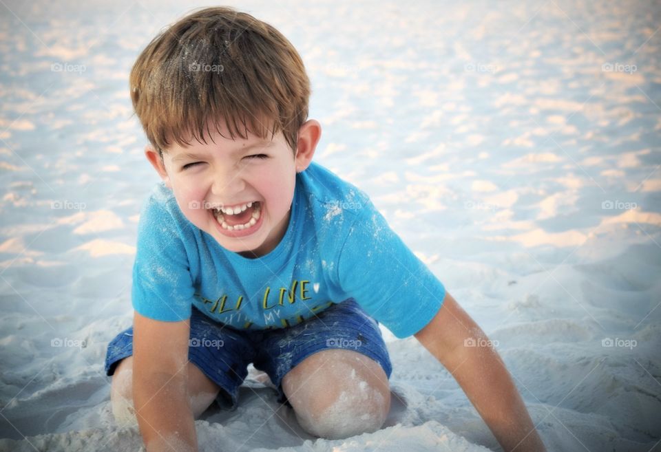 Smiling boy playing in sand