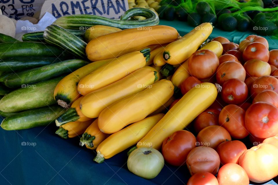  Fresh and organic Yellow squash and tomatoes at a farmers market 