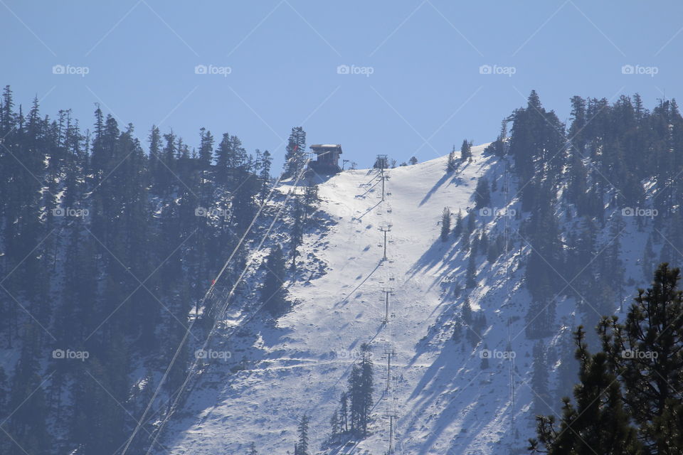 looking from afar at a mountain top ski resort with fresh powder on the slopes. in lake Tahoe Nevada