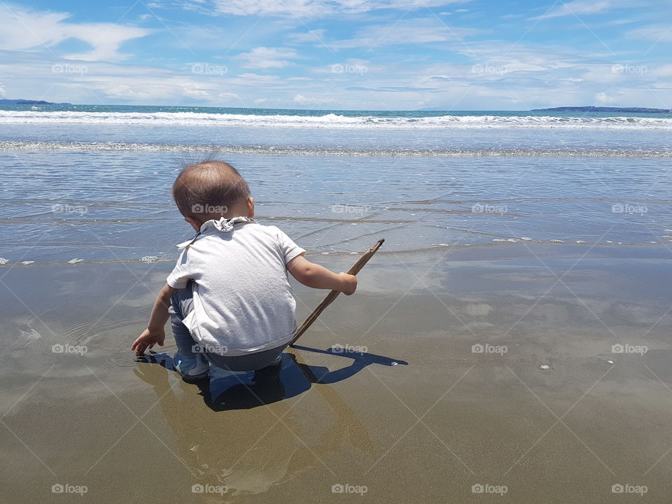 toddler playing at a beach near Auckland  New Zealand