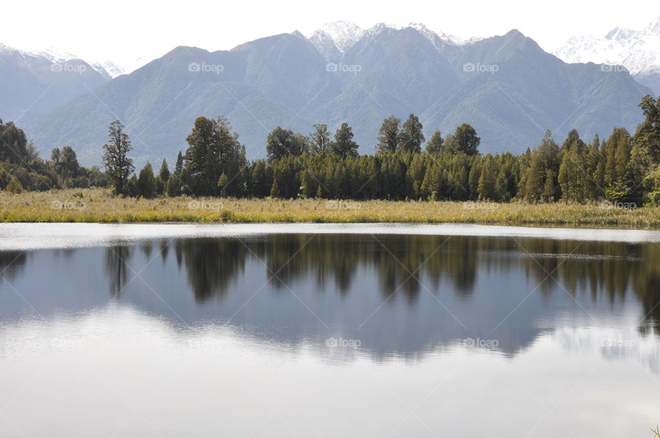 mountains reflected in a still lake