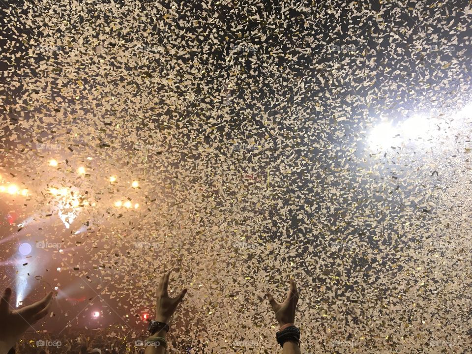 Someone reaching for confetti at the end of a concert. 