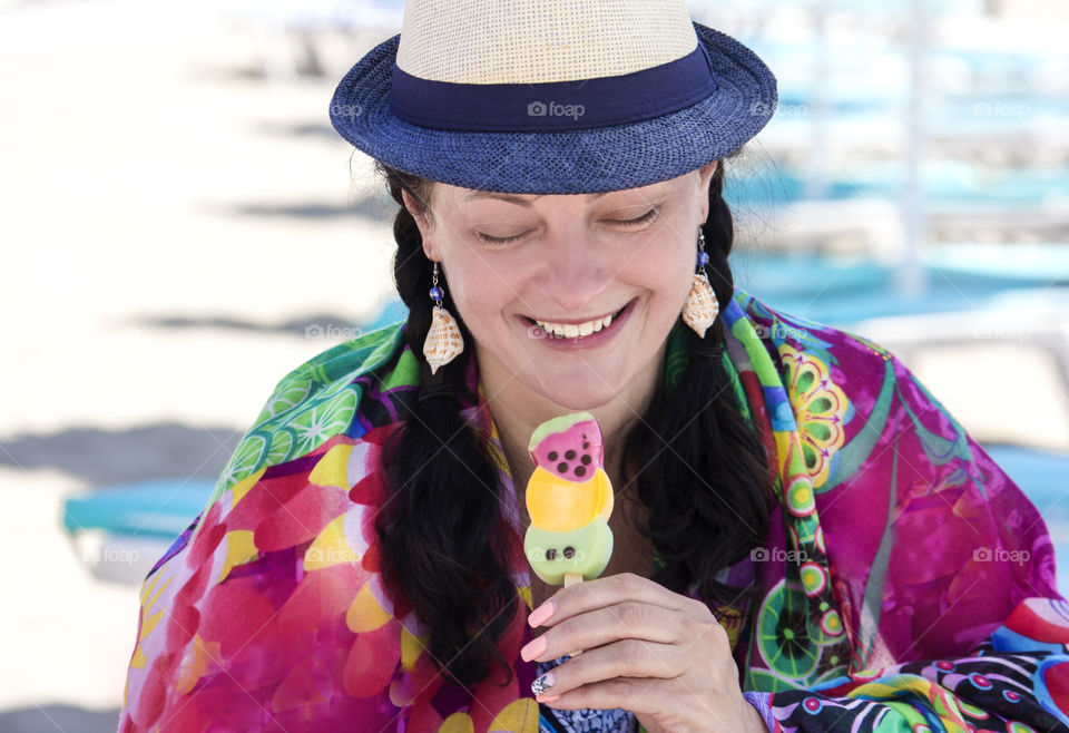 Colorful portrait of beautiful smiling woman holds an ice cream