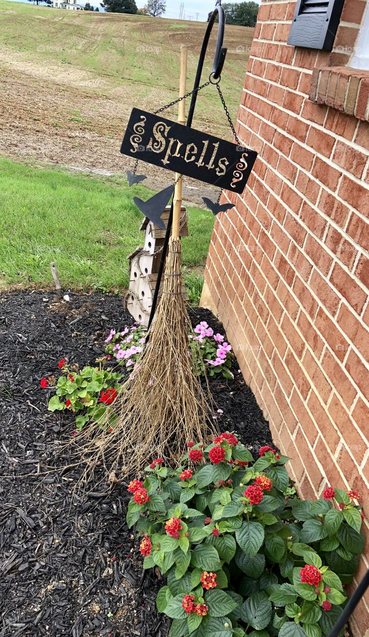 Halloween and garden decorations witch broom and spells tin sign just getting started .....