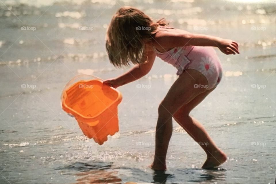 Little girl Playing on beach 