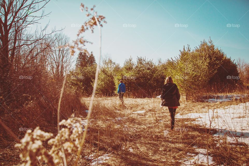 A young couple walking on forest trails