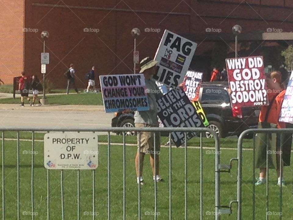 Westboro Baptist church members holding signs to protest an LGB club formed by students of IUPUI.