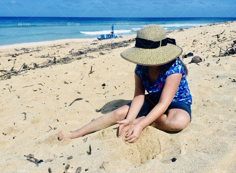 Beautiful photo of little girl in sun hat playing in the sand on a gorgeous sunny afternoon!! 