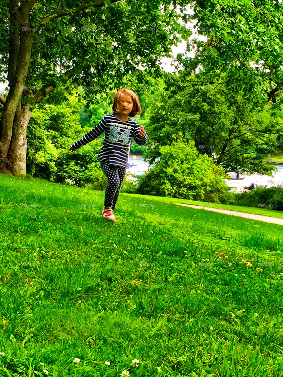 Portrait of a girl walking on grass outdoors