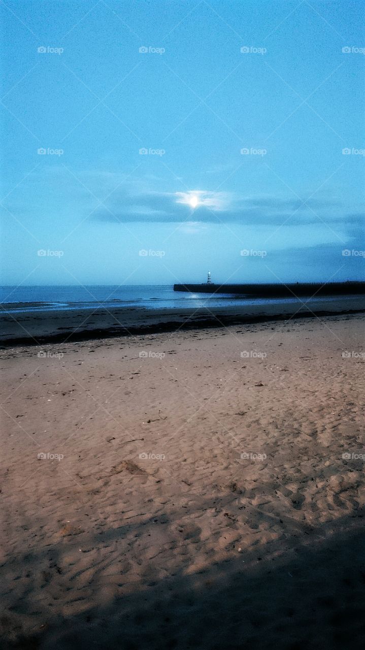 moonlight at the sea front. beautiful night at the sea front with the moon glowing