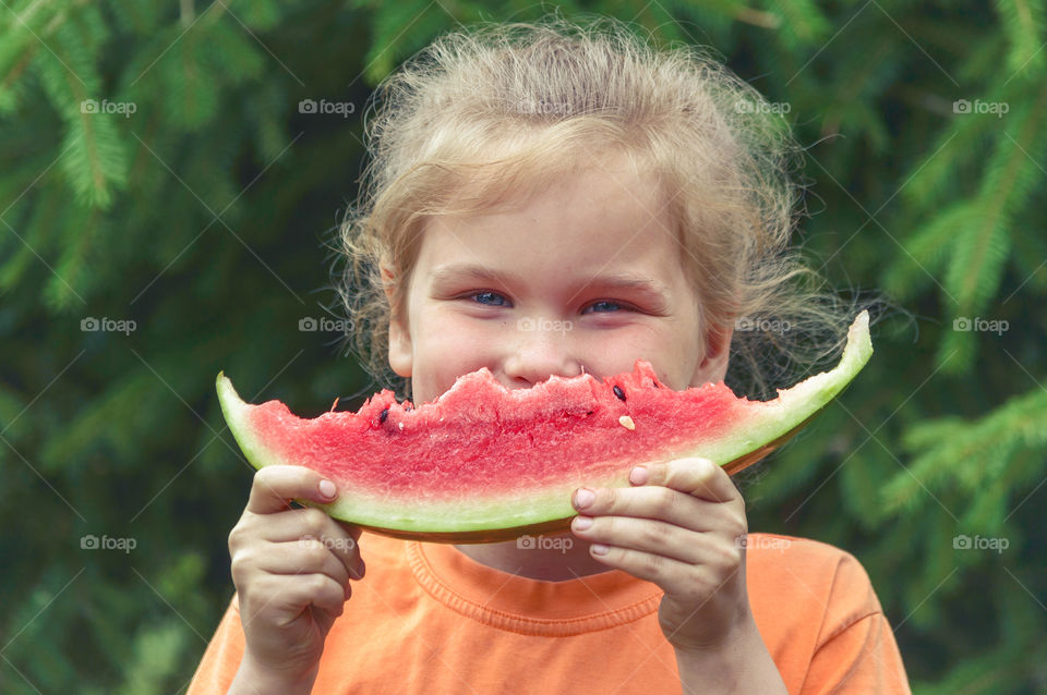 Child is eating watermelon