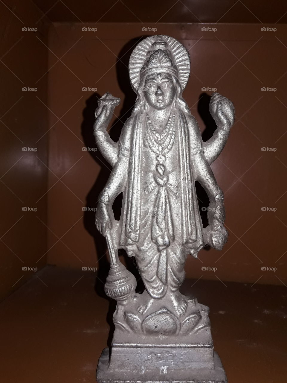 Bronze silver colour statue of Hindus God Lord Bisnu.