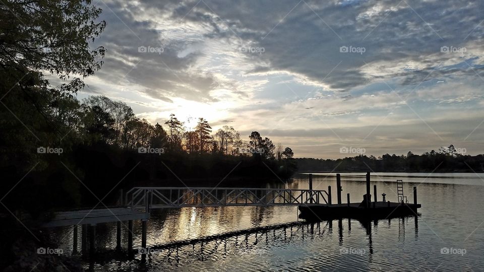 dawn on the lake with a dock view