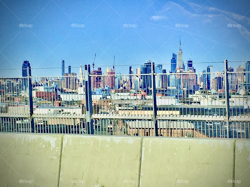 An view from a moving car on route from Forest Green, Bklyn to our destination in Long Island City, Queens, NY on a bright sunny summertime afternoon in 2020. The Empire State Building is within the cityscape in the distance. Hypnotic Productions
