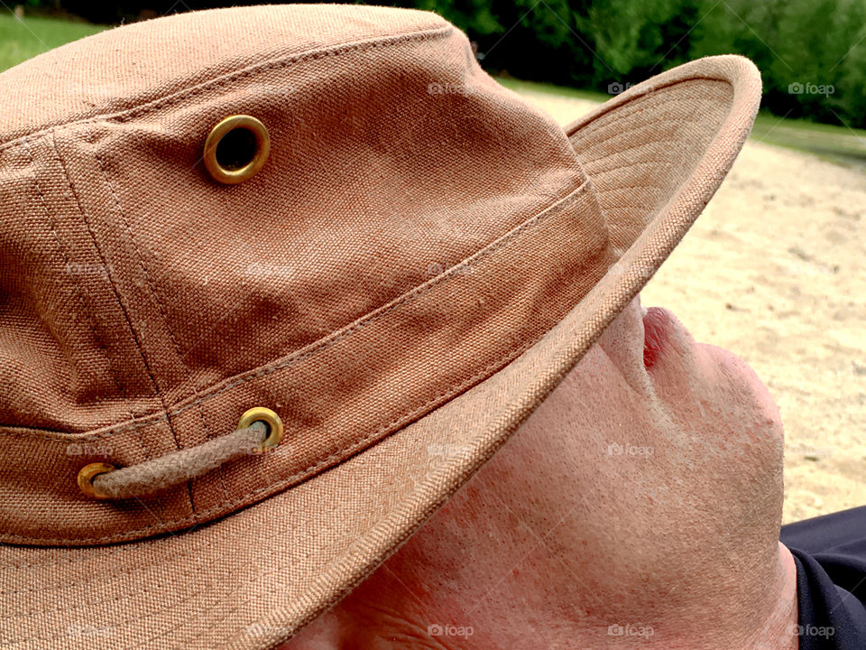 Man sleeping on the beach hat over face