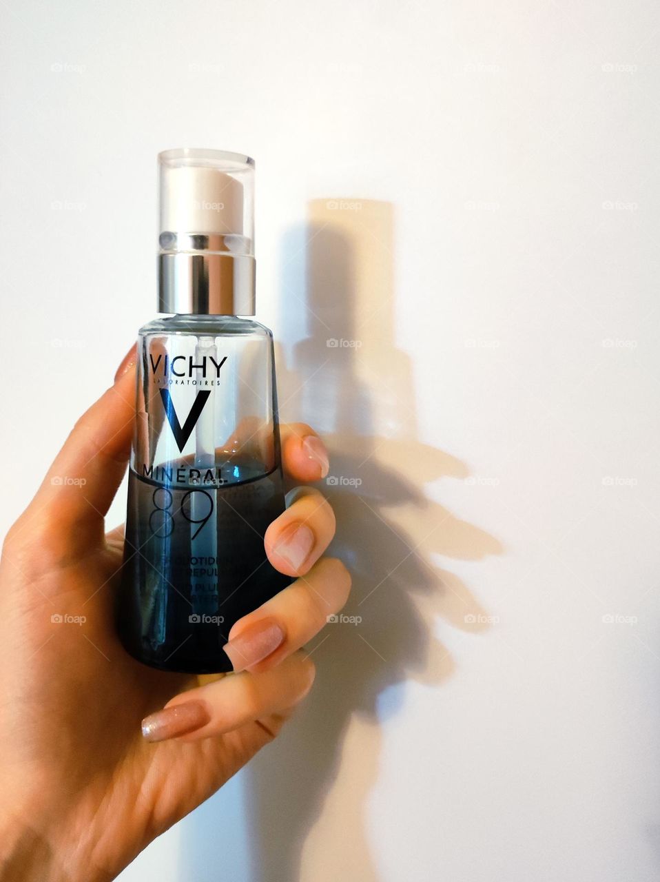 Beauty product in hand/Skincare product Vichy /Holding a beauty skincare product with white background