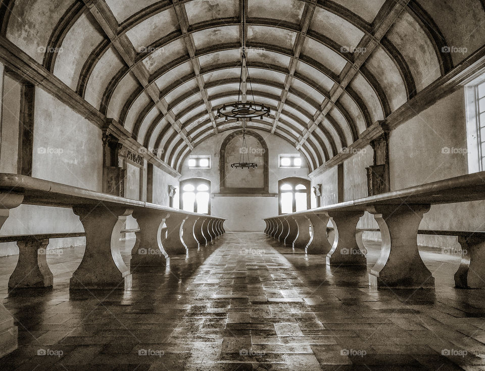 A long dining room, with an arched ceiling at The Convent of Christ, Tomar, Portugal