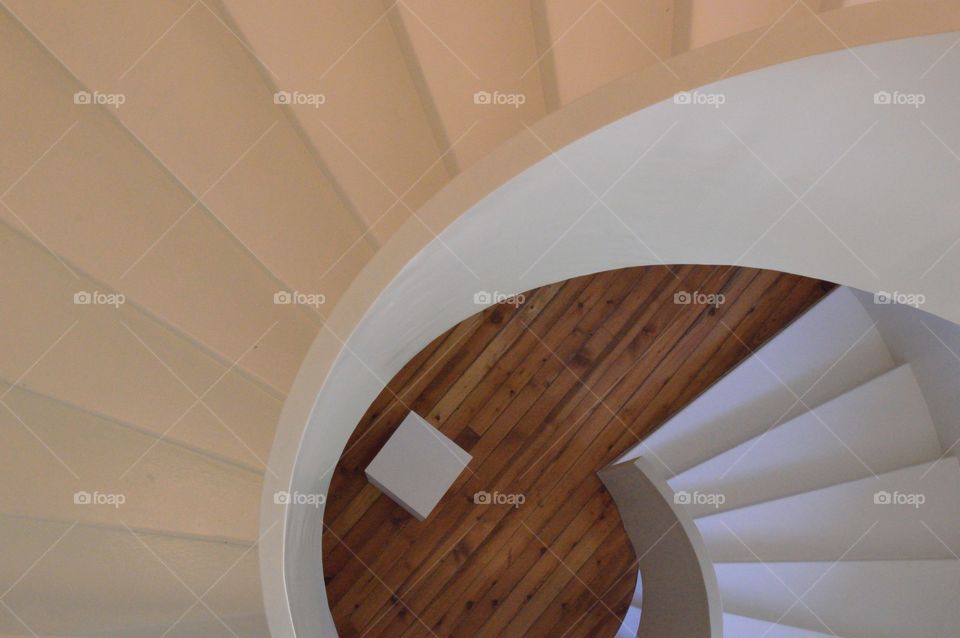 white wooden staircase in the shape of an elliptical