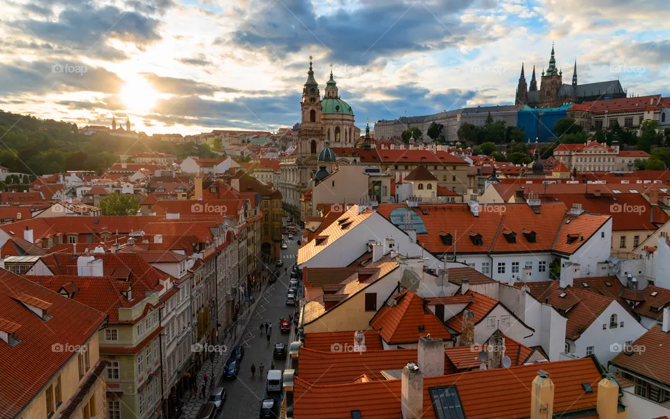 Picturesque sunset in Prague, Czech Republic. The sun breaks through the clouds. View from Malostranska Bridge Tower