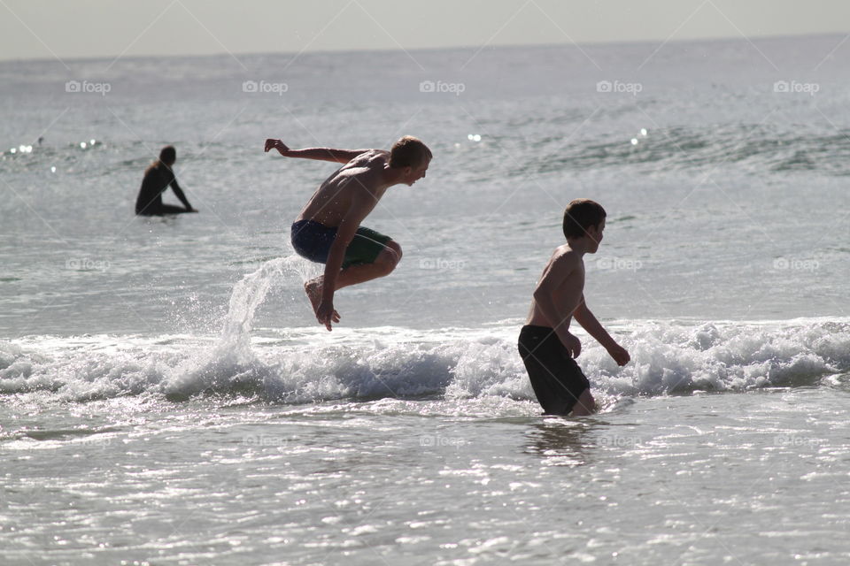 Boys playing in Ocean surf