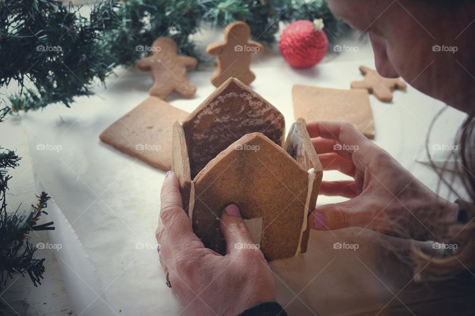 Constructing a homemade gingerbread house.