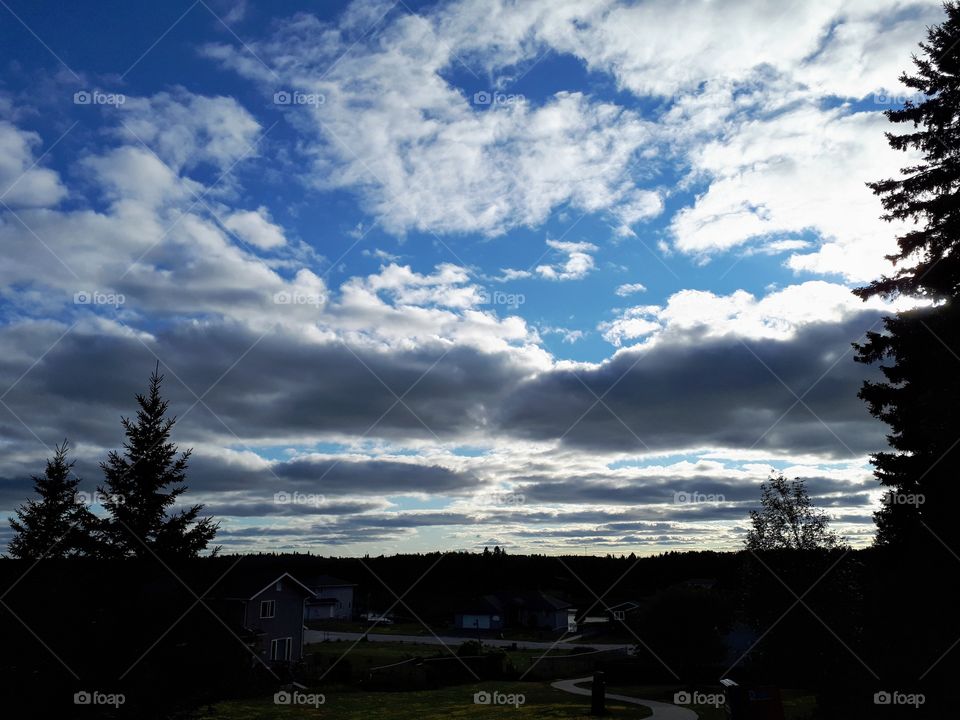 shining evening clouds over a quiet neighborhood