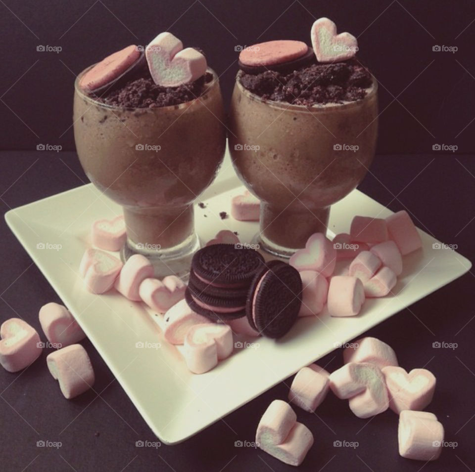 Chocolate milkshake with strawberry filled cookies and heart marshmallows