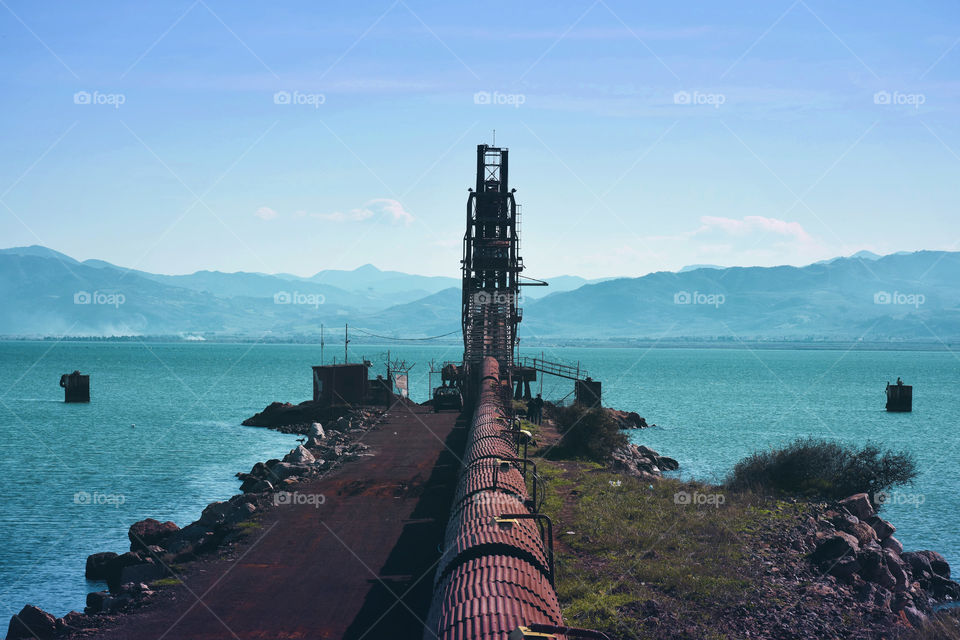 View of machinery in front of sea