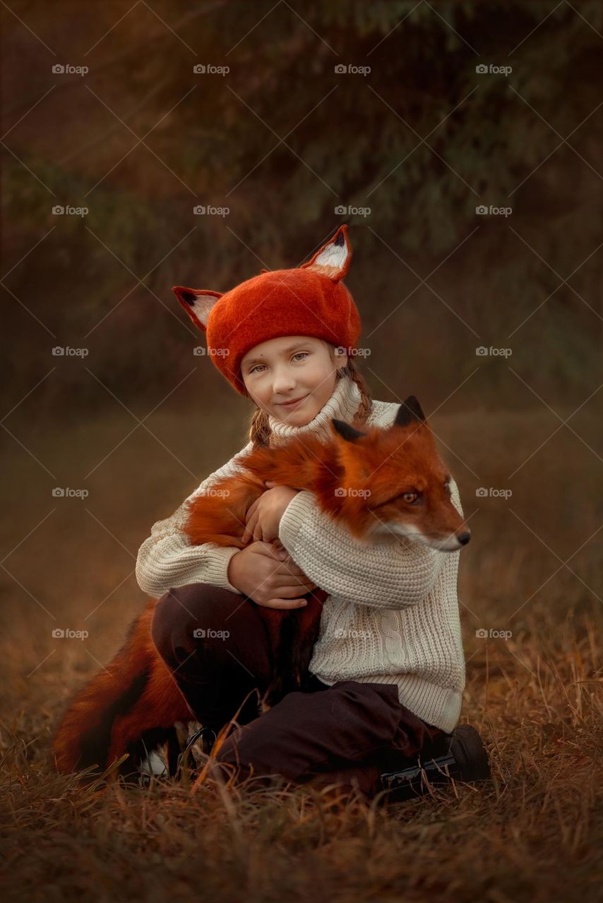 Little girl with fox, outdoor portrait