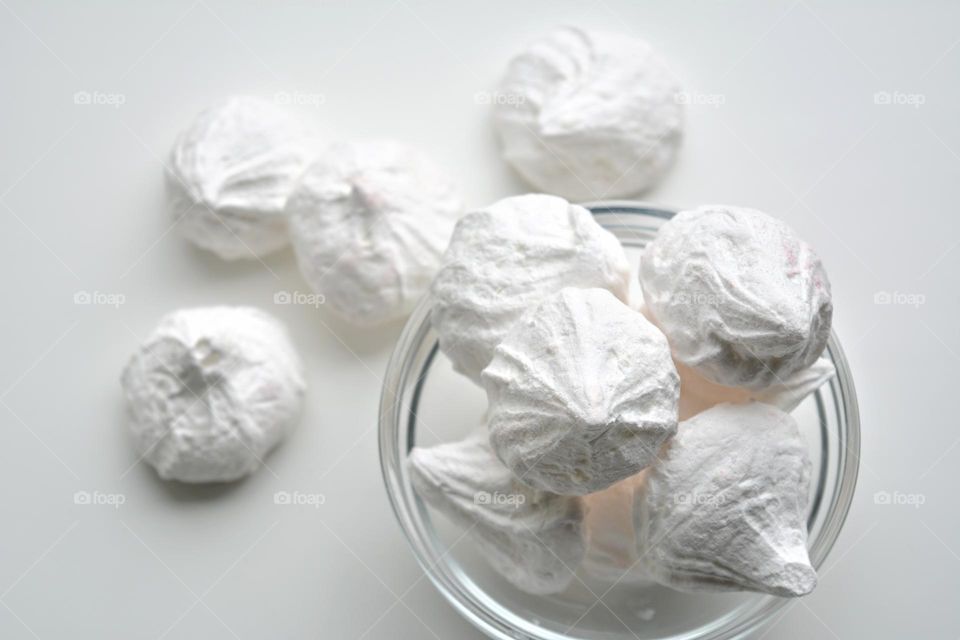 white taste sugar meringues on a white background top view