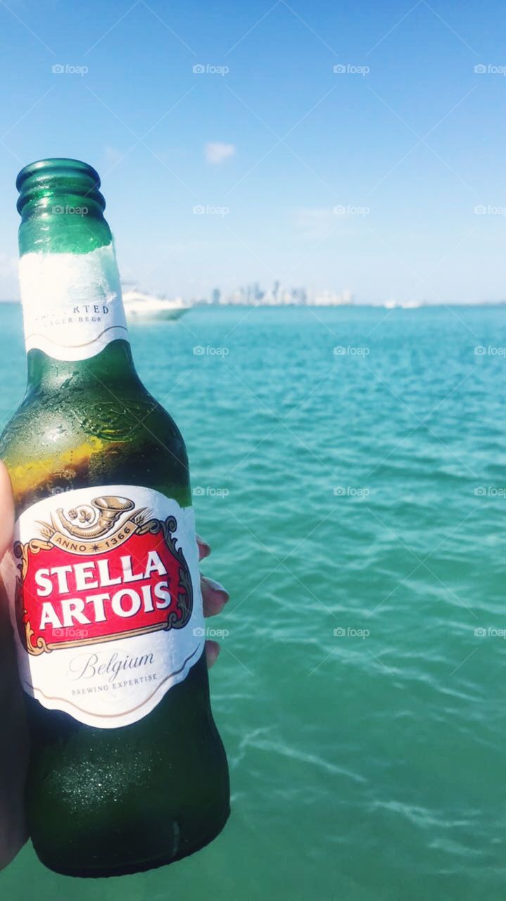 Stella Artois beer with a Miami skyline backdrop 