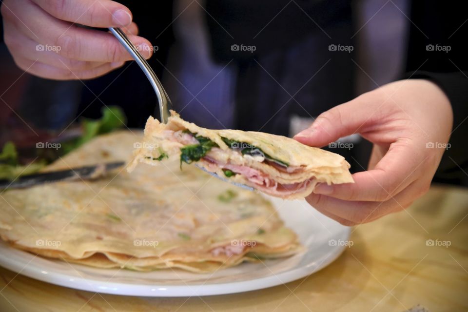 shot of a woman sharing her crepe